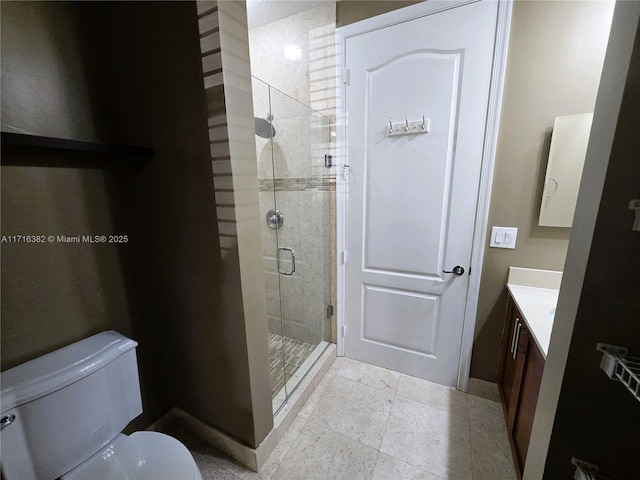 bathroom featuring vanity, toilet, and an enclosed shower