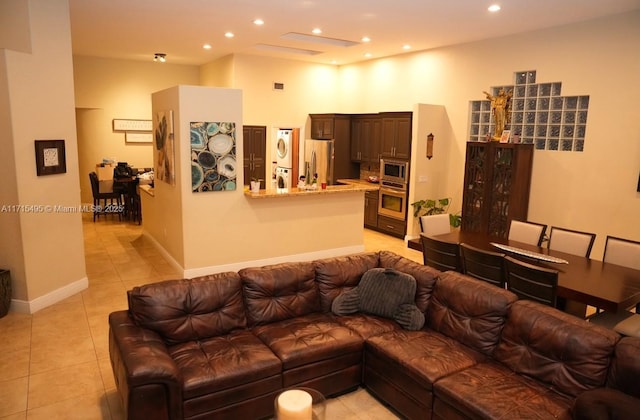 tiled living room with a towering ceiling