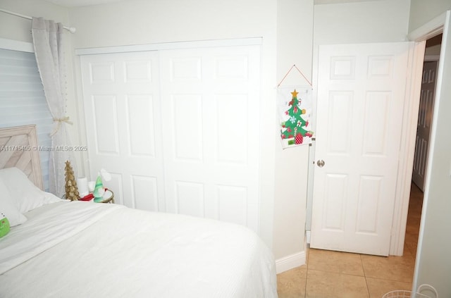 bedroom featuring a closet and light tile patterned floors