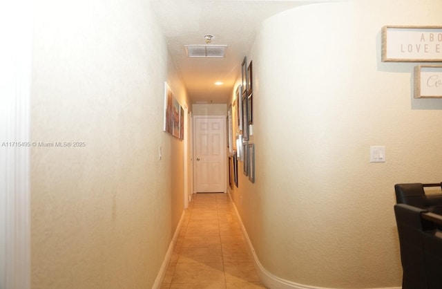 corridor with light tile patterned floors