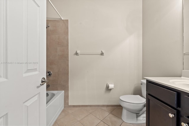 full bathroom with toilet, vanity,  shower combination, tile patterned flooring, and baseboards