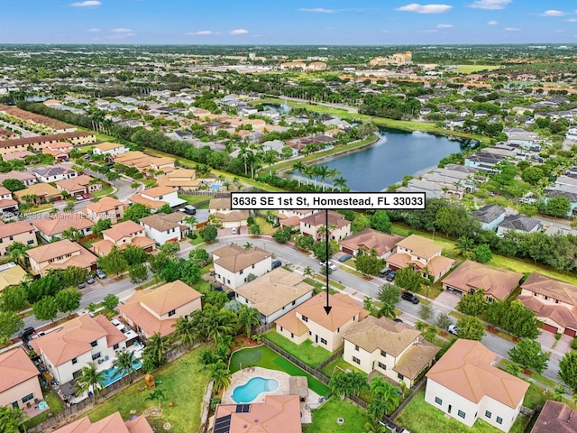 drone / aerial view featuring a water view and a residential view