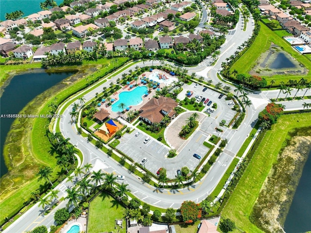 drone / aerial view with a water view and a residential view