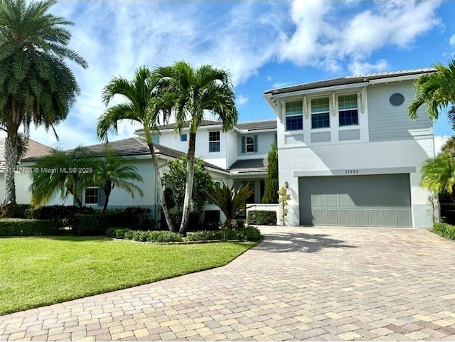 view of front of house featuring a front yard and a garage