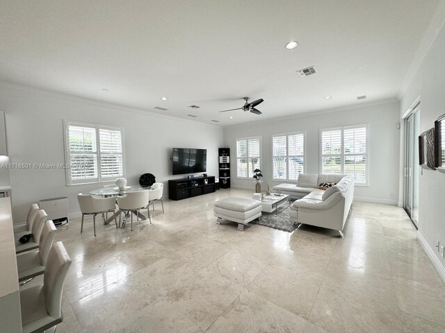 living room featuring crown molding, ceiling fan, and a healthy amount of sunlight