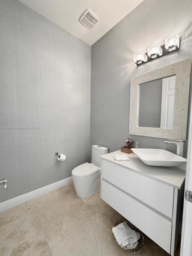 bathroom featuring vanity and toilet