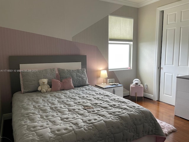 bedroom featuring hardwood / wood-style floors and crown molding