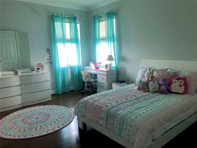 bedroom with ornamental molding and dark wood-type flooring