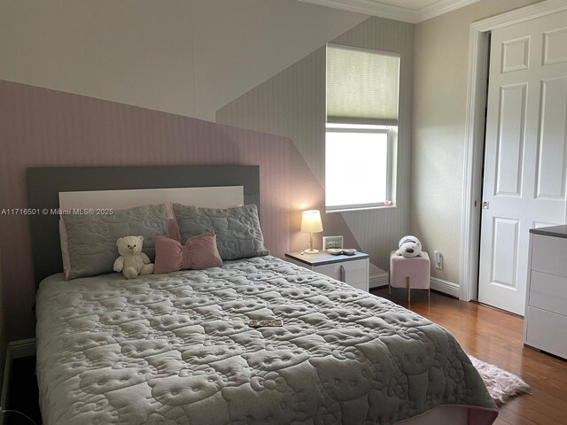 bedroom featuring crown molding and hardwood / wood-style flooring