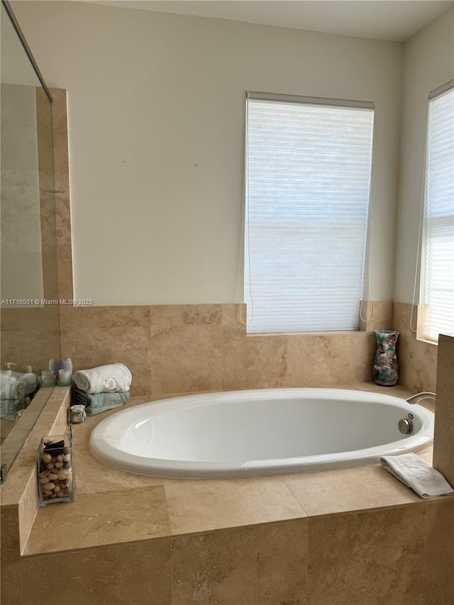 bathroom with a relaxing tiled tub