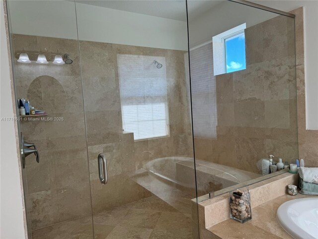 bathroom featuring independent shower and bath