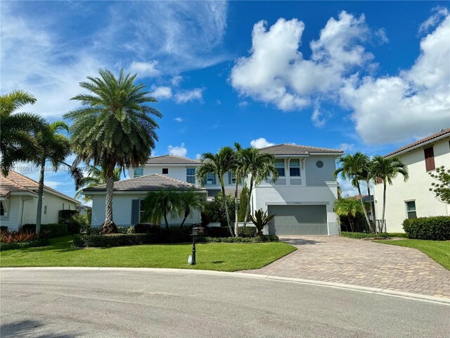 view of front of home with a garage and a front yard