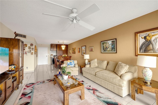 18151 NE 31st Ct Unit 1709, Aventura, FL 33160 - living area featuring light tile patterned floors, a ceiling fan, and a textured ceiling