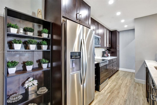 kitchen with backsplash, dark brown cabinets, light hardwood / wood-style floors, and appliances with stainless steel finishes