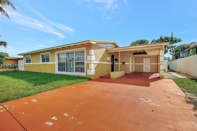 view of front of property featuring a front lawn and a patio