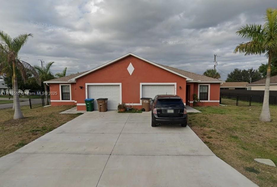 exterior space with a yard and a garage