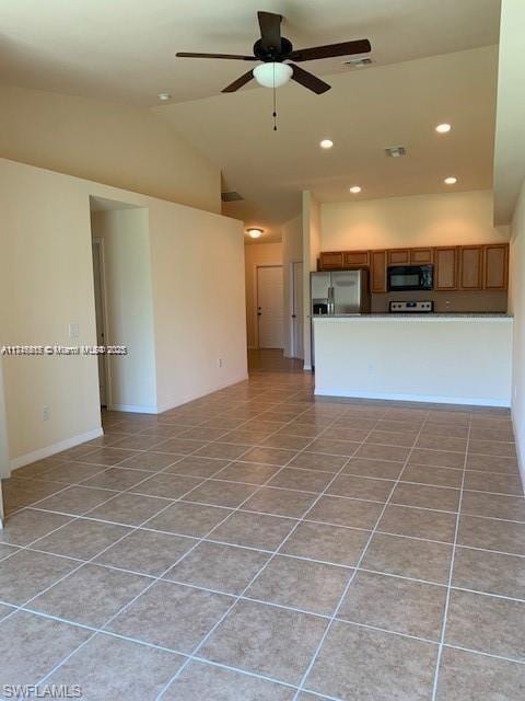 unfurnished living room with ceiling fan, light tile patterned flooring, and lofted ceiling