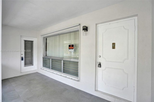 doorway to property featuring stucco siding