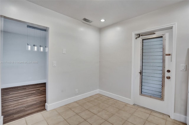 spare room featuring recessed lighting, visible vents, and baseboards