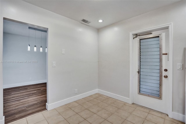 spare room featuring light tile patterned flooring, baseboards, visible vents, and recessed lighting