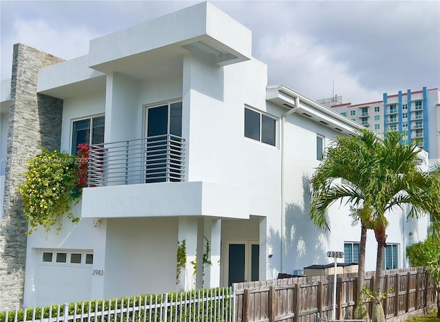 2943 SW 23rd St, Miami, FL 33145 - view of front of home featuring an attached garage, stucco siding, and fence
