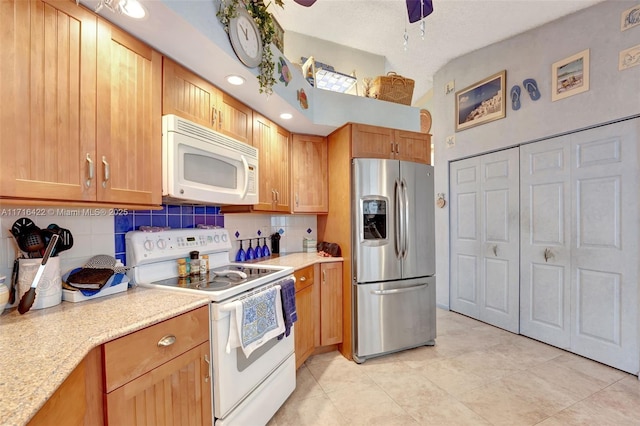 kitchen featuring white appliances, backsplash, ceiling fan, light tile patterned floors, and light stone counters