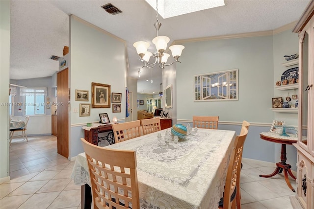 tiled dining area with a textured ceiling, crown molding, and a notable chandelier