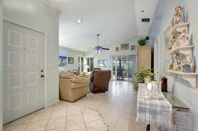 living room with ornamental molding, a textured ceiling, vaulted ceiling, ceiling fan, and light tile patterned floors