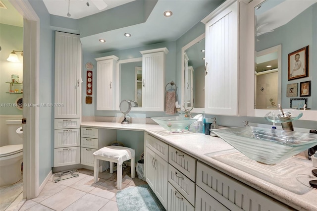 bathroom with vanity, tile patterned floors, ceiling fan, toilet, and walk in shower