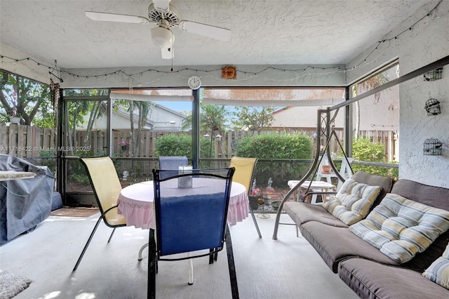 sunroom / solarium featuring ceiling fan and plenty of natural light