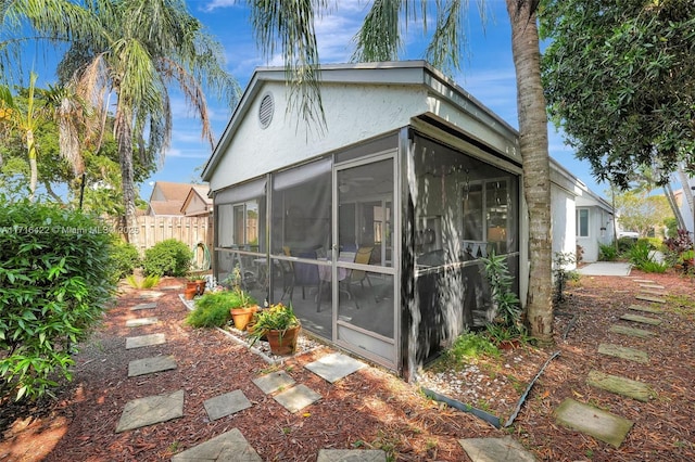 view of side of property with a sunroom