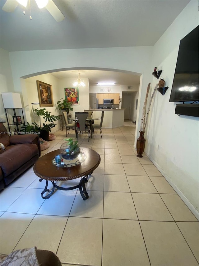 living room featuring ceiling fan and light tile patterned floors