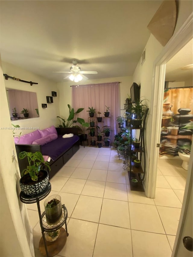 living room with ceiling fan and light tile patterned flooring