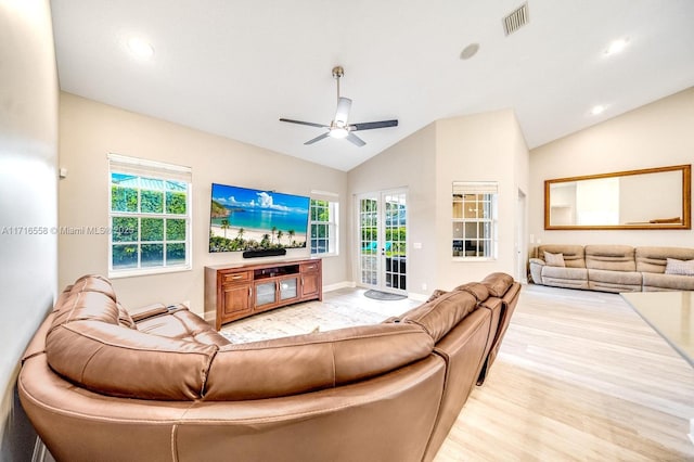 living room with high vaulted ceiling, light hardwood / wood-style flooring, ceiling fan, and a healthy amount of sunlight