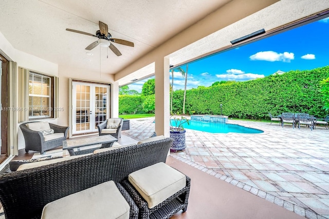 view of patio / terrace featuring ceiling fan, a fenced in pool, and an outdoor living space