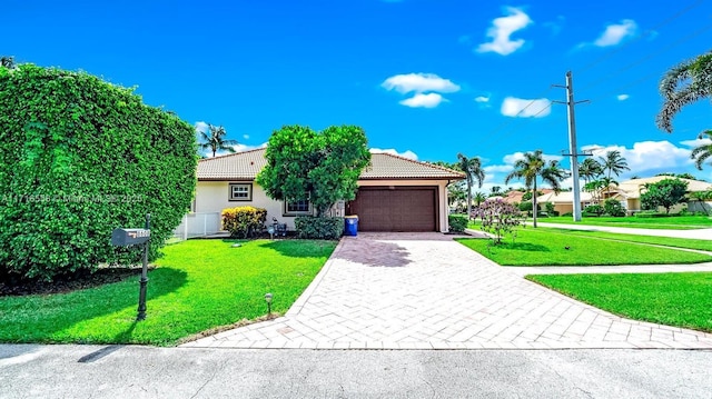 view of front of home featuring a garage and a front lawn