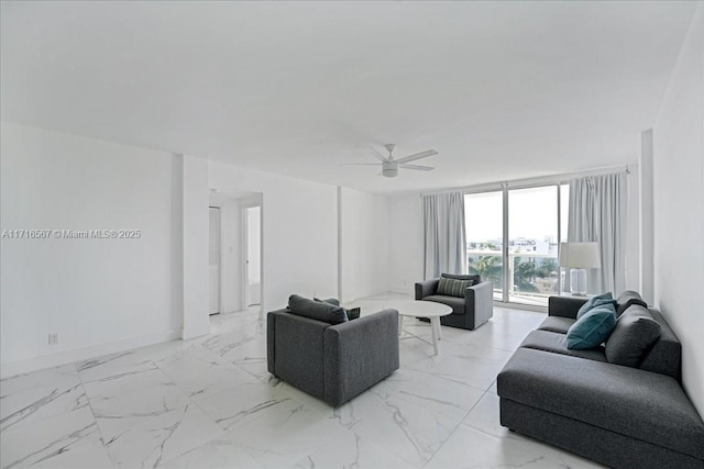 living room with a wall of windows and ceiling fan