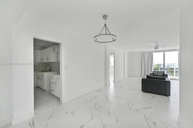 interior space featuring ceiling fan and sink