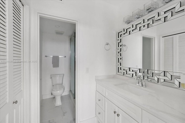 bathroom featuring vanity, toilet, and a shower with door