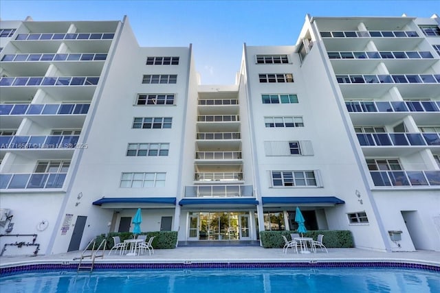 view of building exterior with a community pool