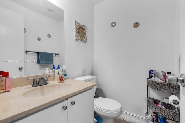 bathroom featuring tile patterned flooring, toilet, and vanity