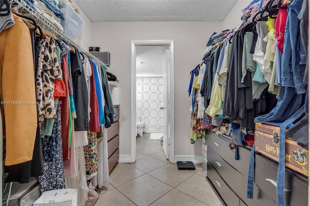 spacious closet featuring tile patterned floors