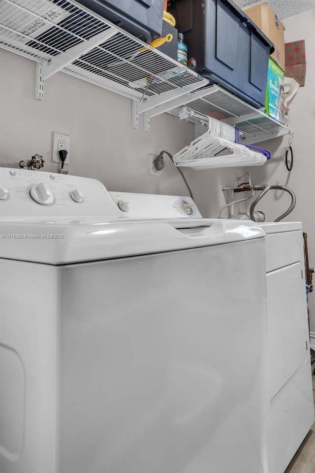 laundry room with laundry area and washing machine and clothes dryer