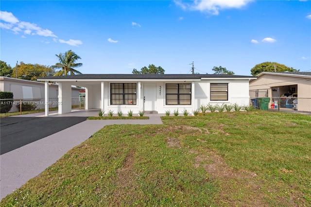 view of front of property with a front lawn and a carport