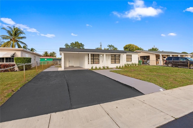 ranch-style home featuring a front yard and a carport