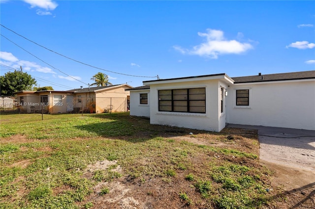 rear view of property with a lawn