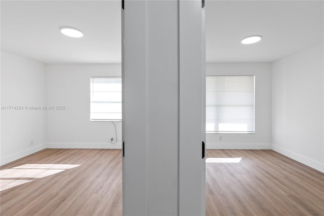 unfurnished room with light hardwood / wood-style floors and a wealth of natural light