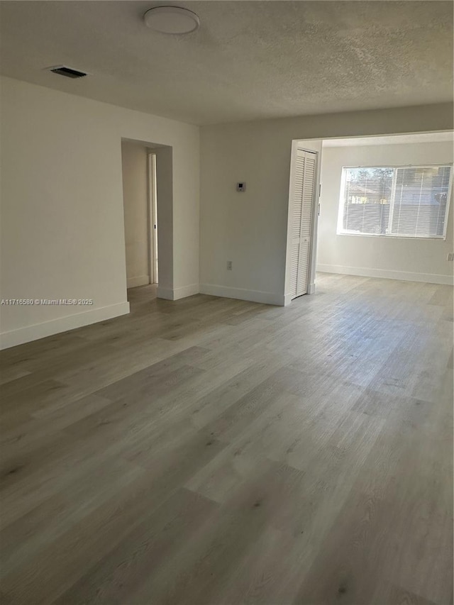 empty room with light hardwood / wood-style floors