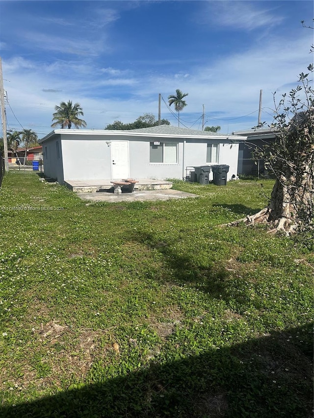 rear view of property with a lawn