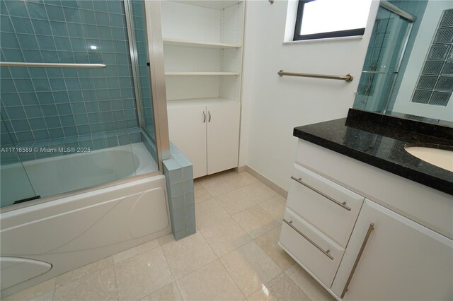 bathroom featuring shower / bath combination with glass door, vanity, and tile patterned flooring